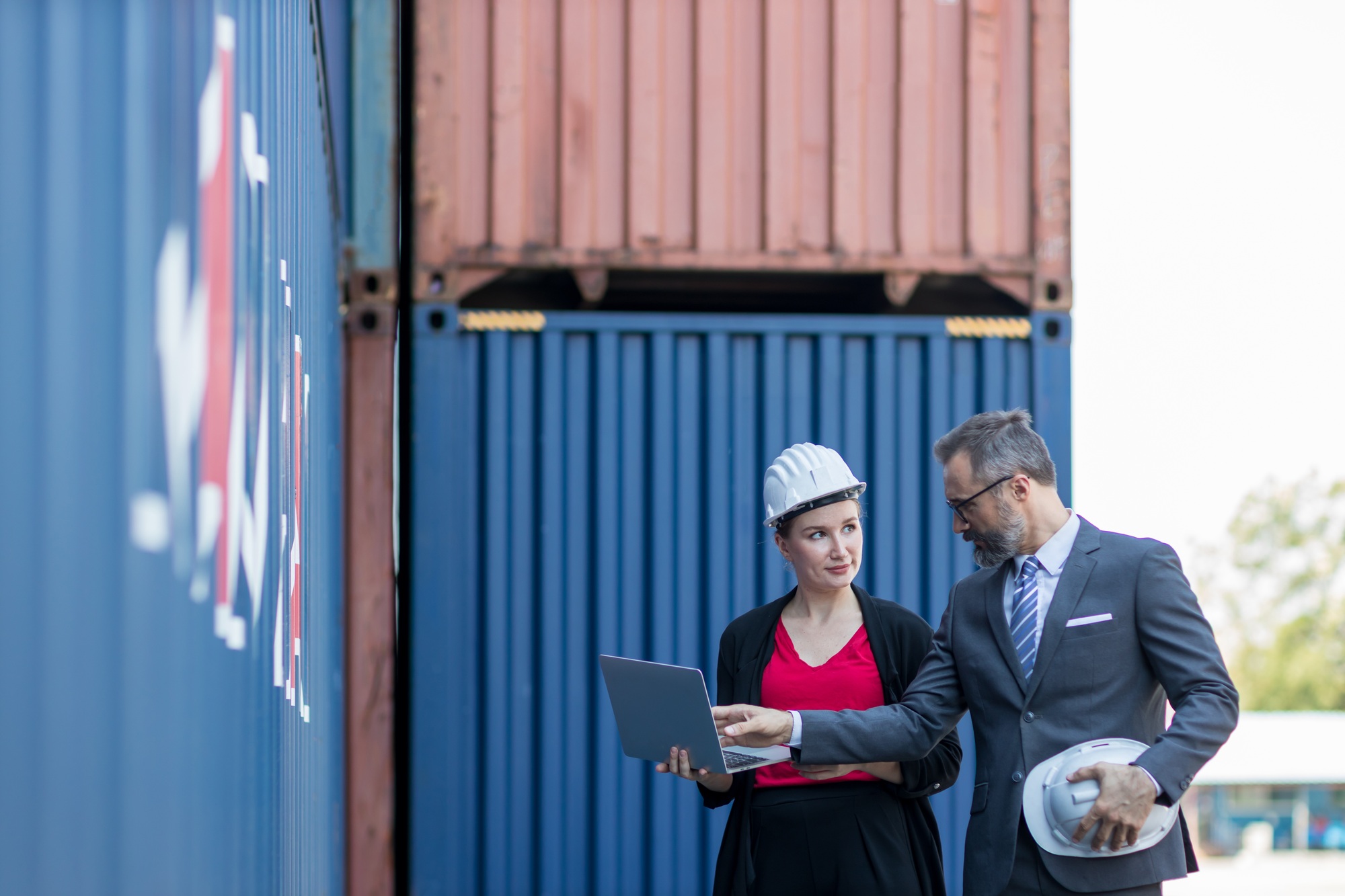 Businessman and Secretary work at Container cargo site check up goods in container.